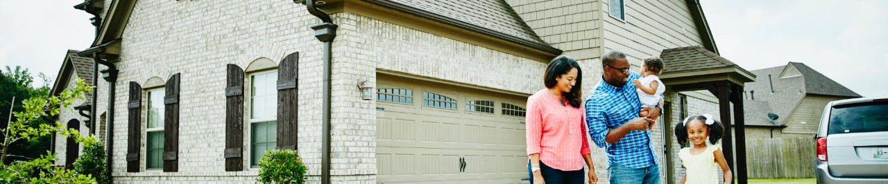 Family standing in front of a house