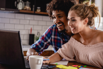 Couple smiling while browsing the Internet